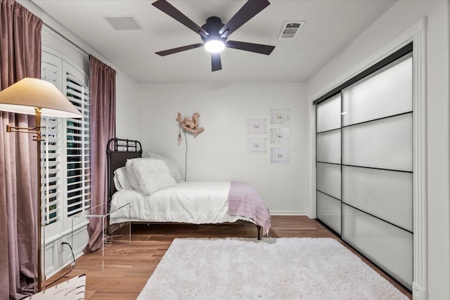 9819 Crestwater Cir, Magnolia, TX 77354 - bedroom with wood finished floors, ceiling fan, and baseboards