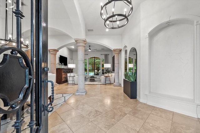 9819 Crestwater Cir, Magnolia, TX 77354 - entrance foyer featuring decorative columns, arched walkways, and a chandelier
