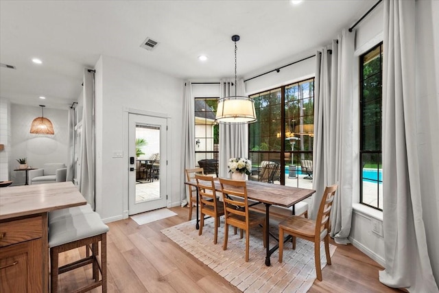 dining space featuring a healthy amount of sunlight and light wood-type flooring