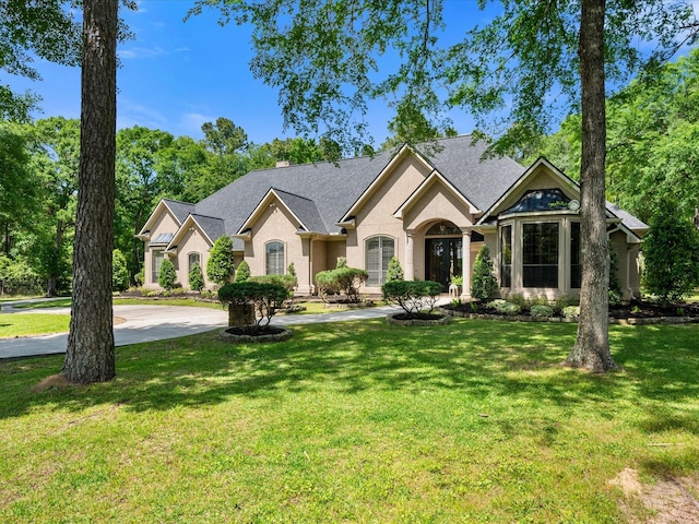 9819 Crestwater Cir, Magnolia, TX 77354 - view of front facade with stucco siding and a front yard