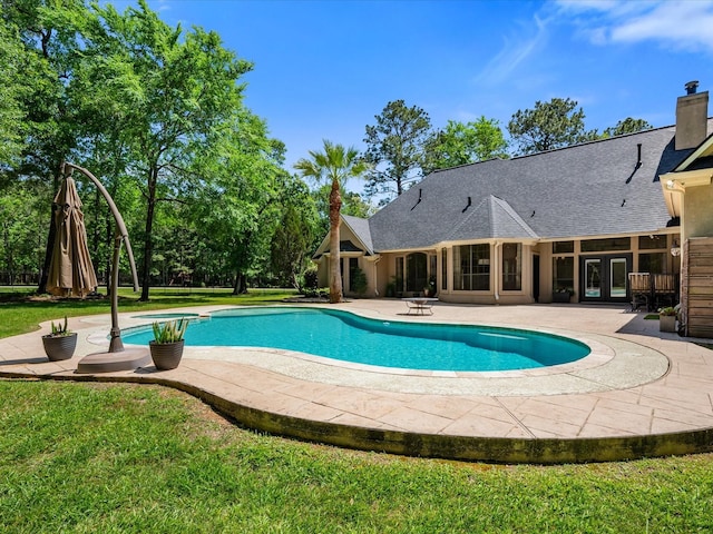 9819 Crestwater Cir, Magnolia, TX 77354 - swimming pool with a patio area, a lawn, and french doors