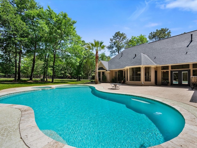 9819 Crestwater Cir, Magnolia, TX 77354 - view of pool featuring a patio area, french doors, and a pool with connected hot tub