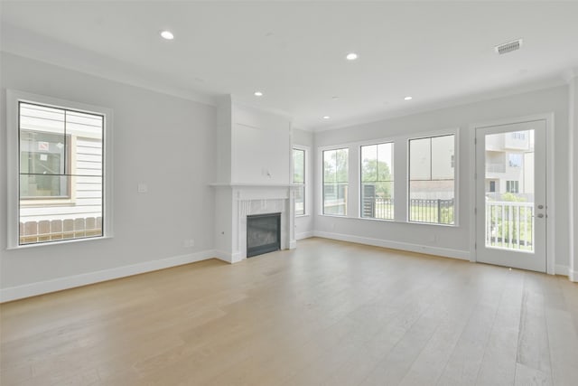 unfurnished living room featuring ornamental molding and light hardwood / wood-style floors