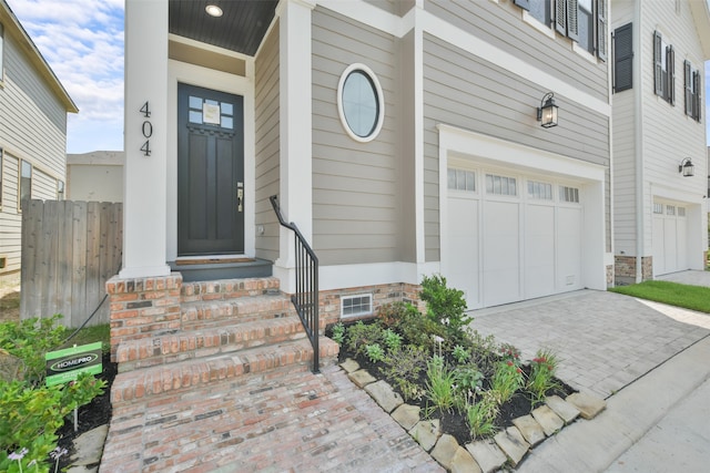 doorway to property with a garage