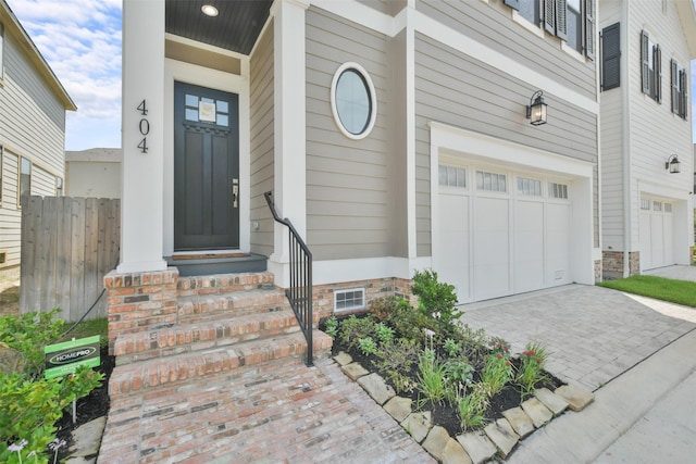 view of exterior entry with a garage