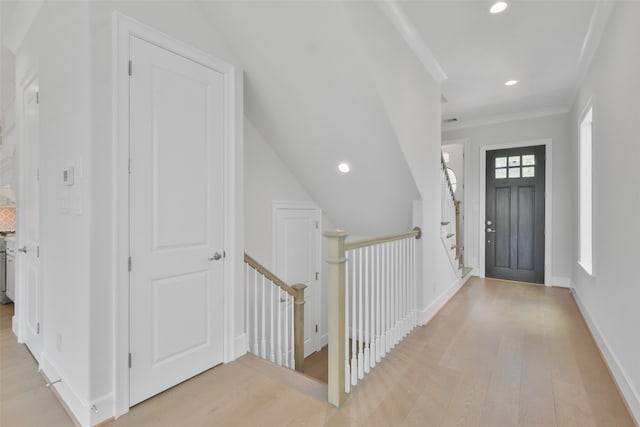 foyer entrance featuring light hardwood / wood-style flooring and ornamental molding