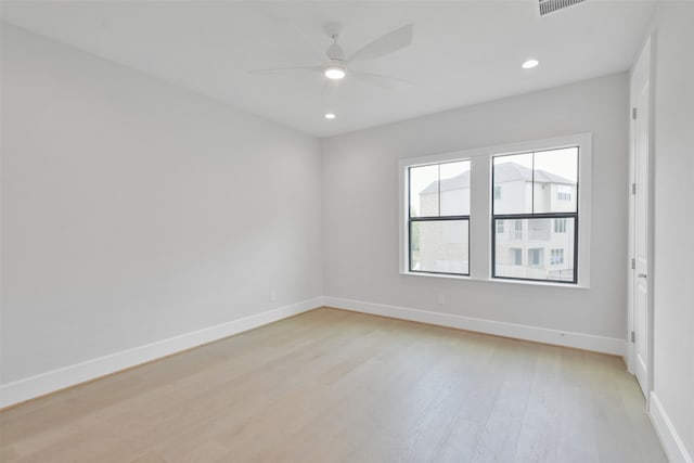 empty room with ceiling fan and light hardwood / wood-style floors