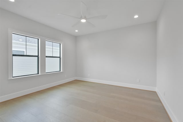 spare room featuring light wood-type flooring and ceiling fan