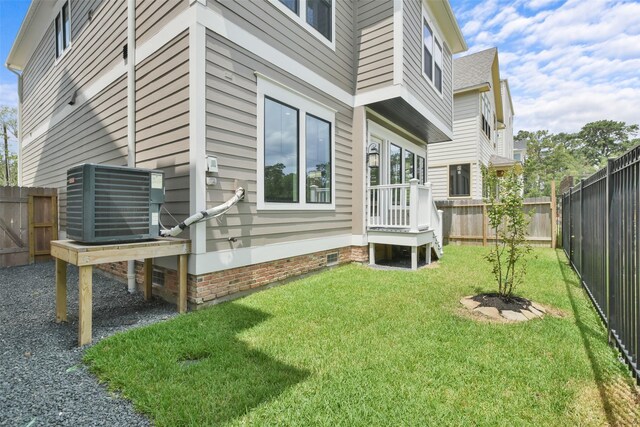 exterior space featuring central AC and a yard