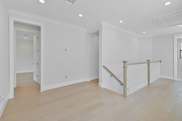 unfurnished room featuring light wood-type flooring and crown molding