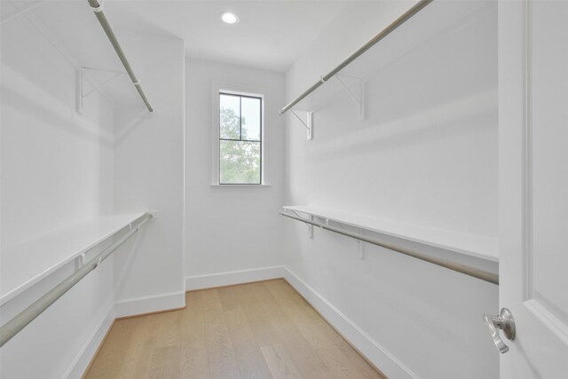 spacious closet with light hardwood / wood-style floors