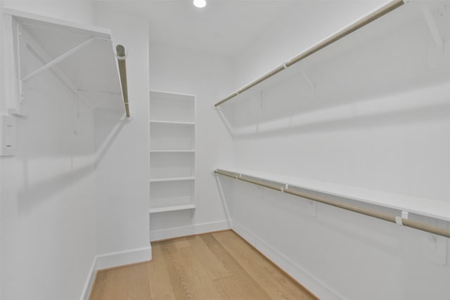 spacious closet featuring light hardwood / wood-style floors