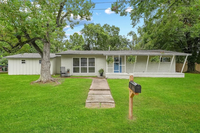 rear view of property with a lawn