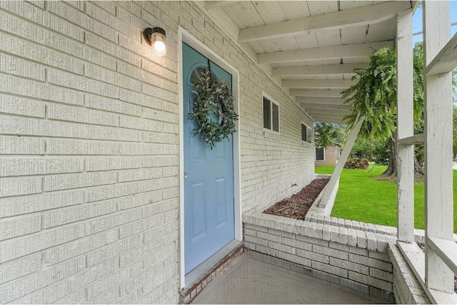 entrance to property with a lawn