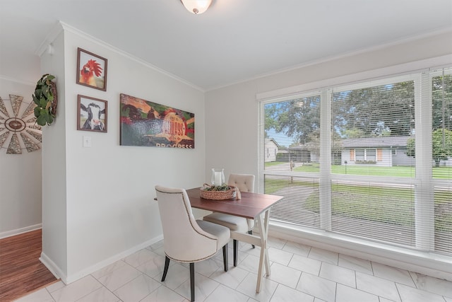 dining room featuring light wood-type flooring and ornamental molding