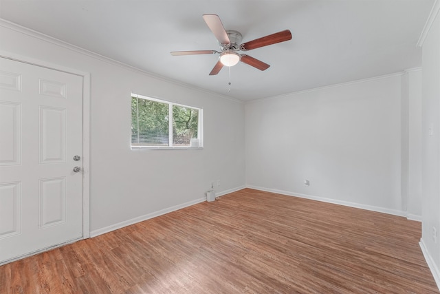 empty room featuring hardwood / wood-style flooring, crown molding, and ceiling fan