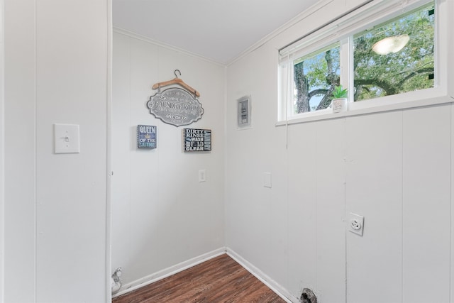 laundry room with dark wood-type flooring, electric dryer hookup, and crown molding