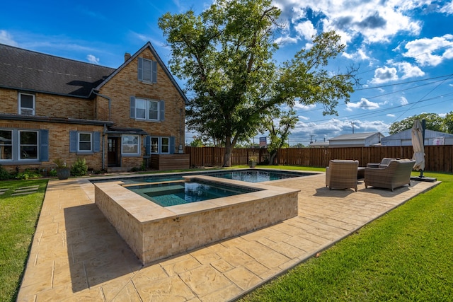 view of swimming pool featuring an in ground hot tub, outdoor lounge area, a lawn, and a patio area