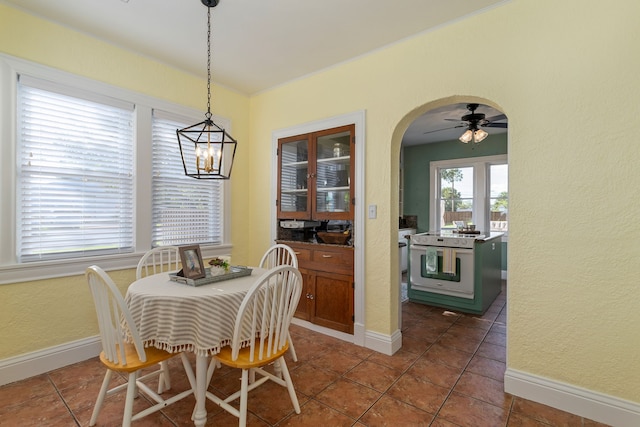 tiled dining room with ceiling fan