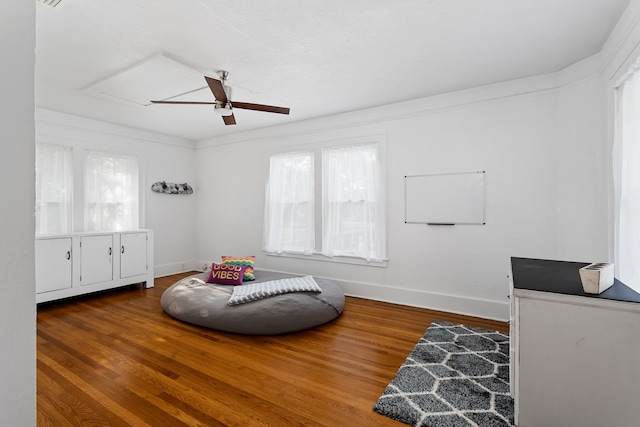 sitting room featuring hardwood / wood-style flooring, ceiling fan, and ornamental molding