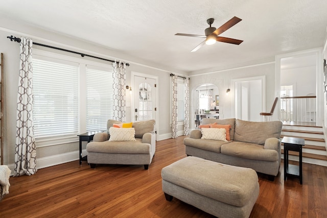 living room with dark hardwood / wood-style floors, a textured ceiling, and ceiling fan