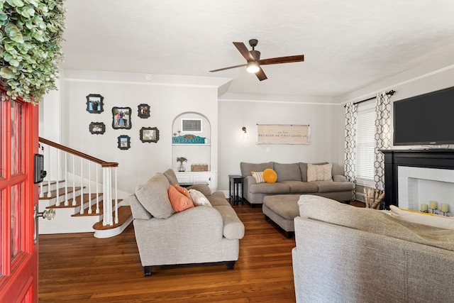 living room with dark hardwood / wood-style floors and ceiling fan