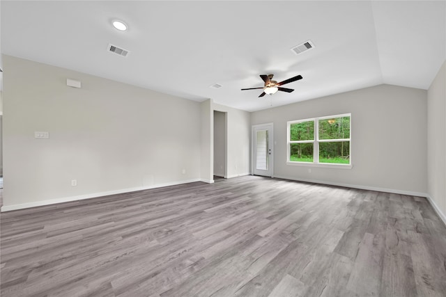 empty room with vaulted ceiling, ceiling fan, and light hardwood / wood-style flooring