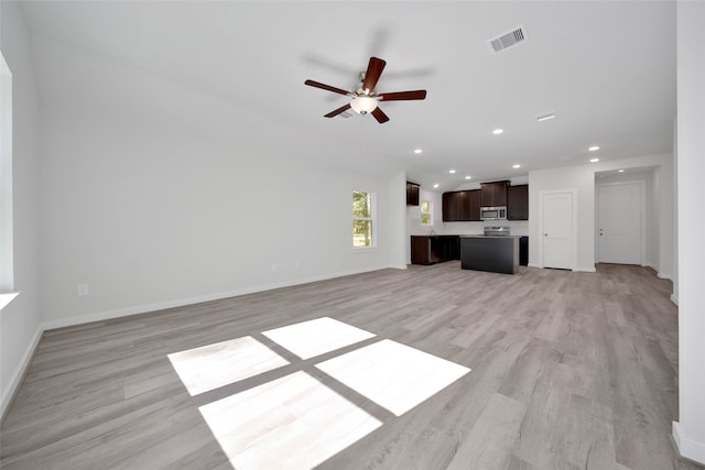 unfurnished living room with ceiling fan and light hardwood / wood-style flooring