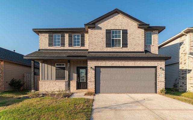 view of front of property with a front yard and a garage