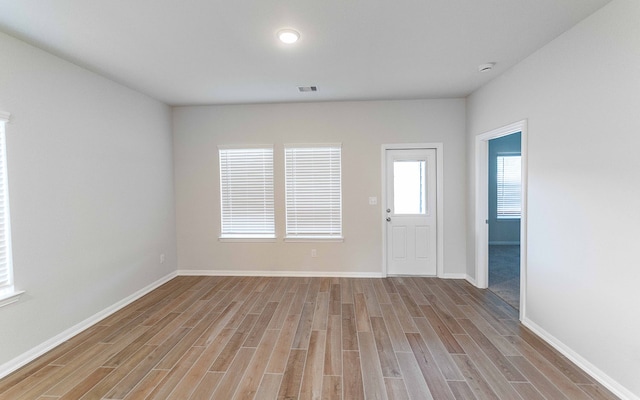 spare room featuring light wood-type flooring