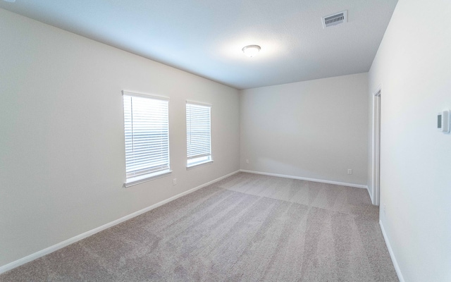 spare room with light colored carpet