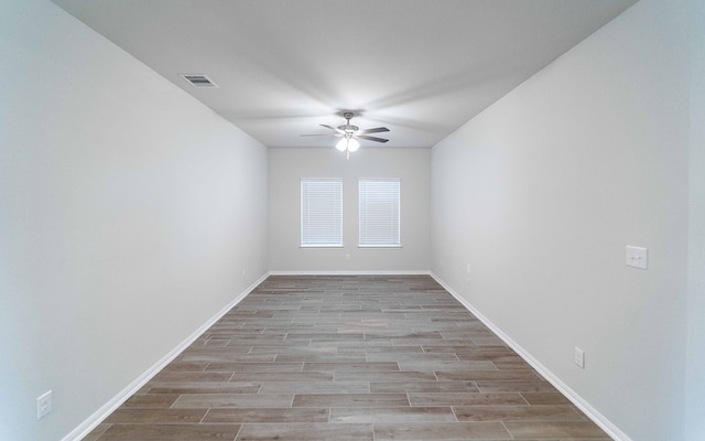 spare room featuring light hardwood / wood-style flooring and ceiling fan