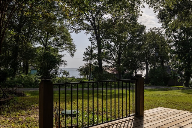 view of gate featuring a lawn and a water view