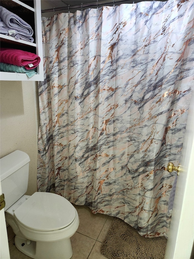 bathroom featuring tile patterned floors and toilet