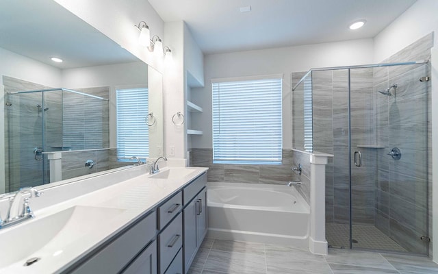 bathroom featuring a sink, a shower stall, and double vanity