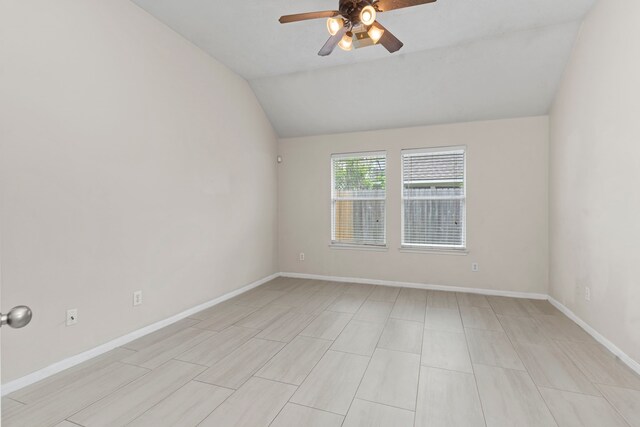 spare room featuring ceiling fan and lofted ceiling