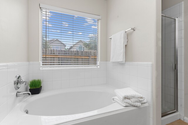 bathroom featuring separate shower and tub