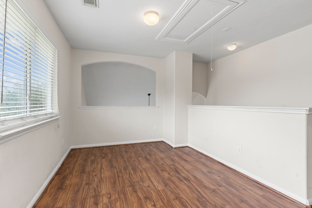 spare room with dark wood-type flooring