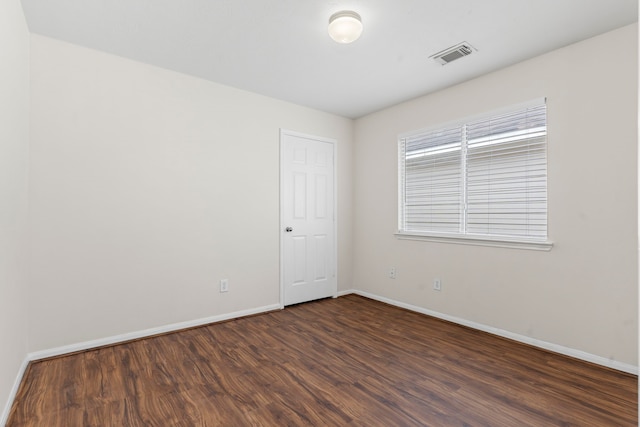 empty room featuring dark wood-type flooring