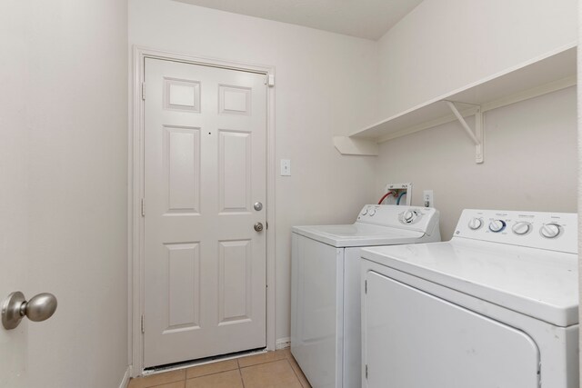 laundry room featuring light tile patterned floors and washer and dryer