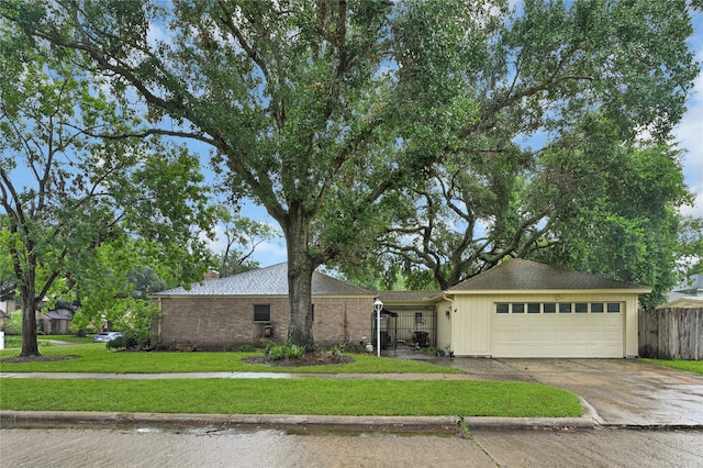 single story home with a garage and a front lawn