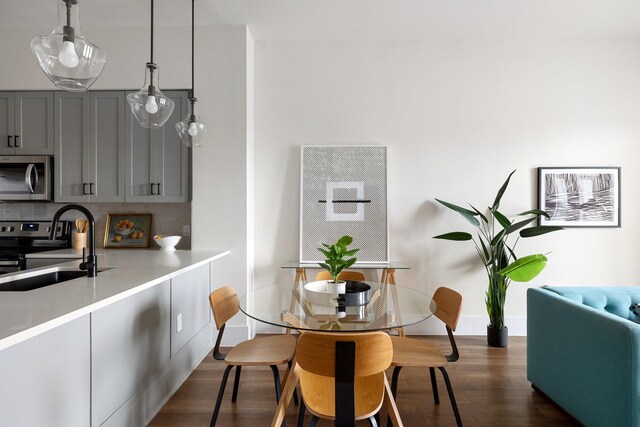 dining area with sink and dark wood-type flooring