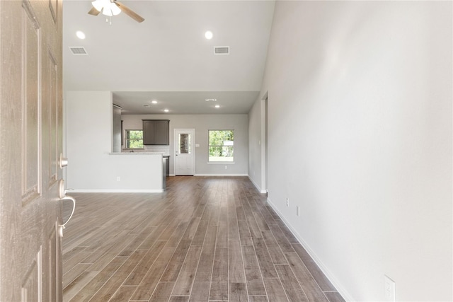 unfurnished living room with wood-type flooring and ceiling fan