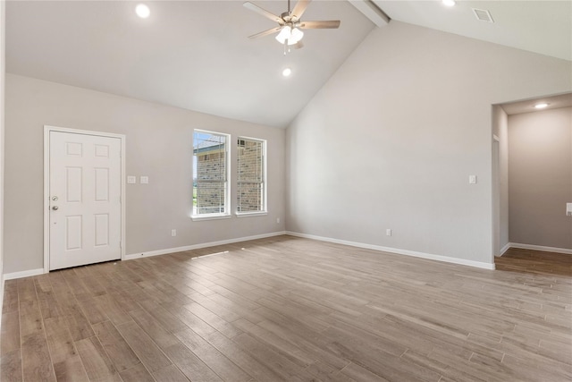 spare room featuring beamed ceiling, light hardwood / wood-style flooring, ceiling fan, and high vaulted ceiling