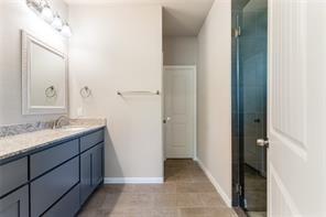 bathroom featuring tile patterned flooring and vanity