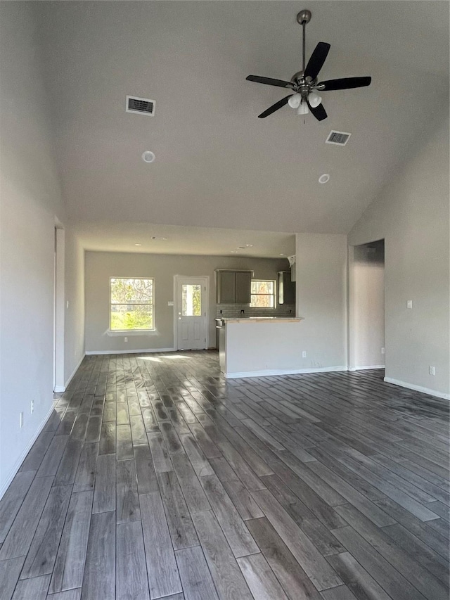 unfurnished living room featuring lofted ceiling, ceiling fan, and dark hardwood / wood-style floors