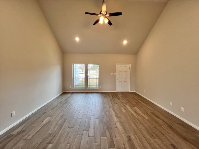 unfurnished living room with ceiling fan, wood-type flooring, and high vaulted ceiling