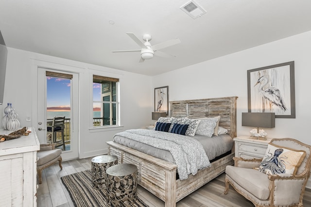 bedroom with light hardwood / wood-style floors, access to outside, and ceiling fan