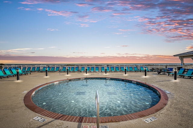 view of pool at dusk