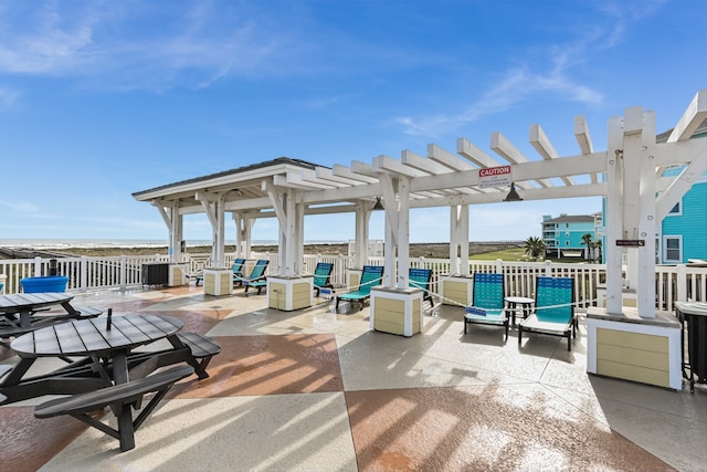 view of patio / terrace with a water view and a pergola